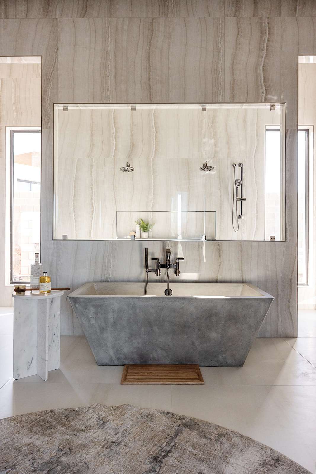 Refined bathroom with a freestanding tub and stone tile