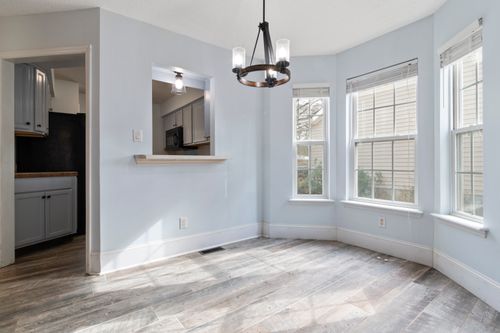 Sunlit room with warm wood flooring